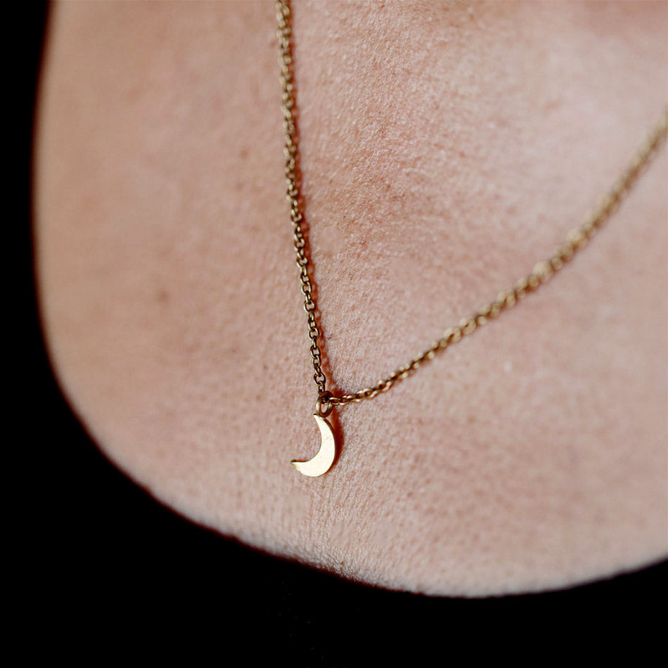 Fair trade brass moon necklace handmade by survivors of human trafficking.