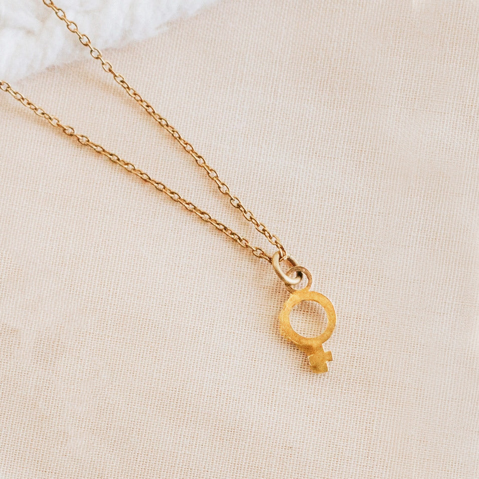 Fair trade woman's symbol necklace handmade by survivors of human trafficking.